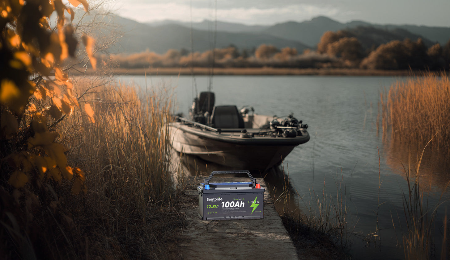 Sentorise 12.8V 100Ah low-profile DIN battery by a boat at the lake